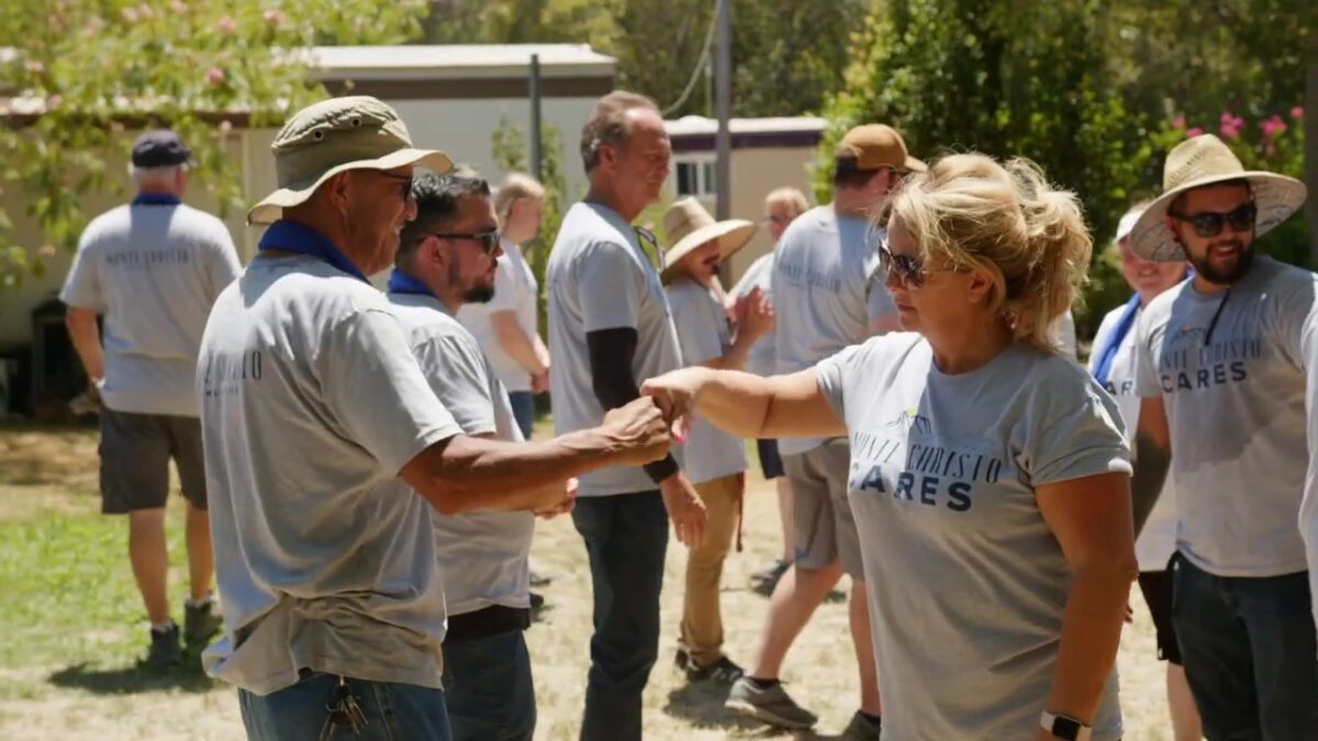 volunteers-fist-bump-while-working-together-outdoors