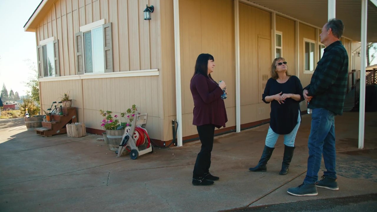Residents and staff talking outside a manufactured home
